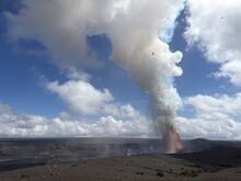 Tall orange lava fountains rising from Kīlauea's summit at night