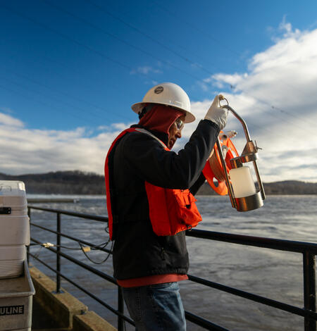 Hydrologic technician Fisseha Mengistu reels in a sampling bottle.