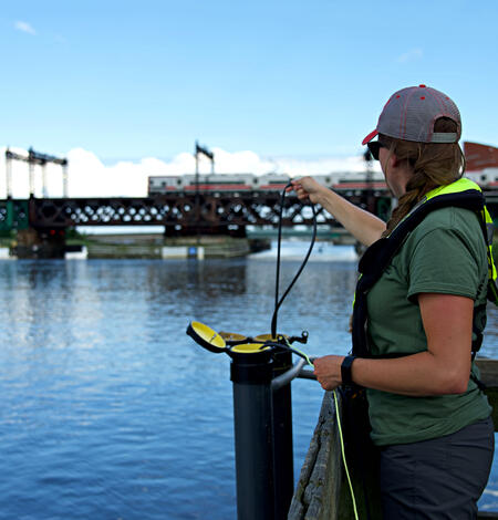 New England WSC hydrologic technician inspecting the continuous water quality monitoring equipment 