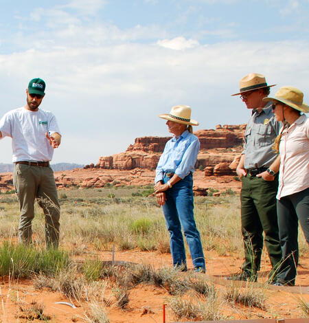 A USGS scientist talks to National Park Service, BLM and a rancher about a grassland drought experiment in Canyonlands NP