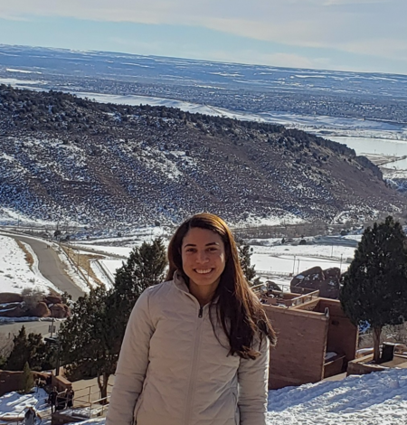 TNMCorps volunteer jessicasouza in front of a snowy landscape. 