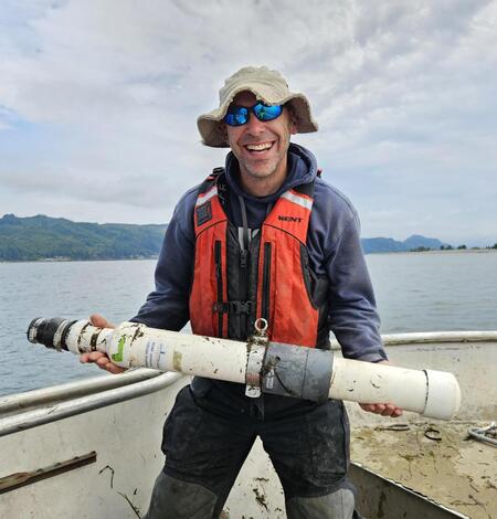 Researcher, Ryan Tomka, holding a telemetry receiver for tracking fish
