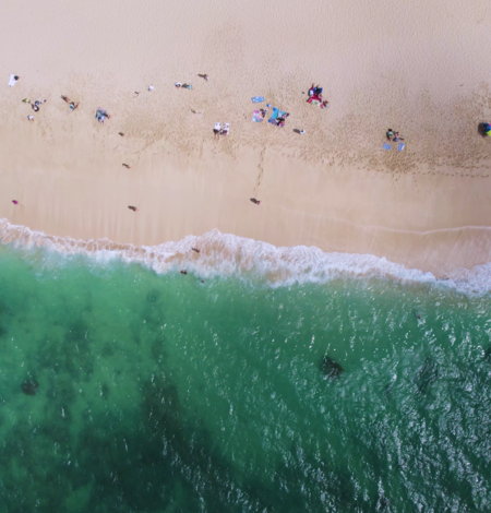 Aerial top-down footage of sandy shoreline on Oahu