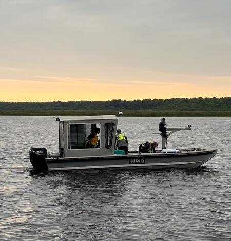 USGS research boat on river at dawn