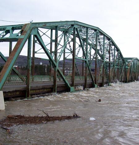 St. John River threatens to swamp a steel bridge.