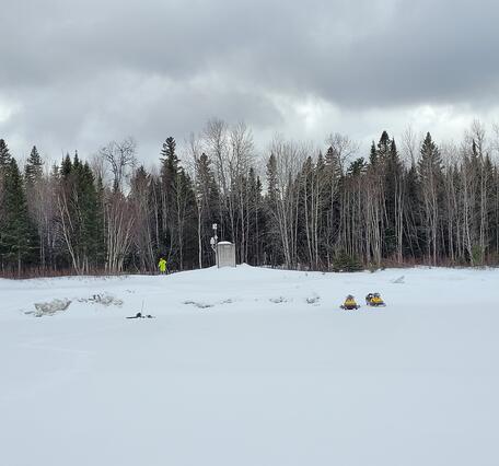 A streamgage in a wintery scene