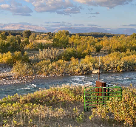 Streamgage on Birch Creek during fall, surrounded by cattle guards 