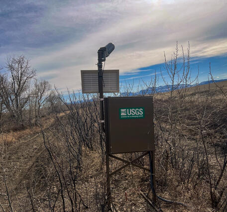 View of streamgage box looking at the mountains during spring