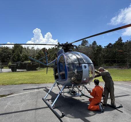 Color photograph of helicopter being prepared for flight