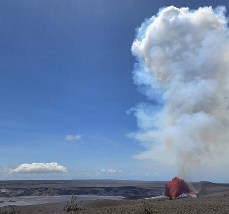 Color photograph of lava fountain within caldera