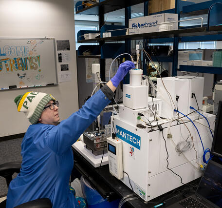 scientist working on a chemical analyzer