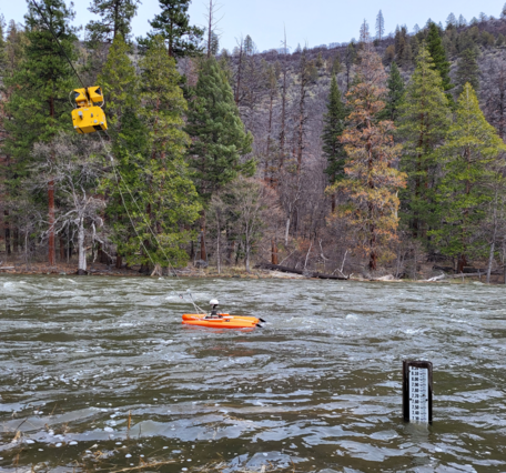 measuring equipment pulled by a yellow cableway system