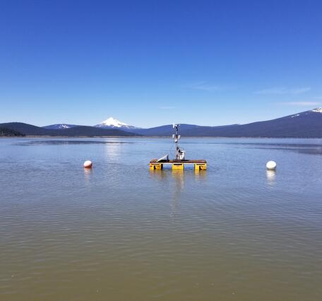 floating platform on upper Klamath Lake. Blue sky over lake water with distant snow capped mountain
