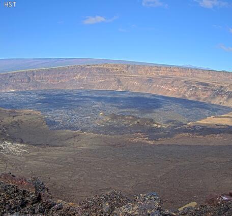 Color photograph of eruption within volcanic crater in summit caldera