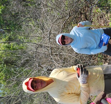 Interns smiling for a picture in a coastal wetland