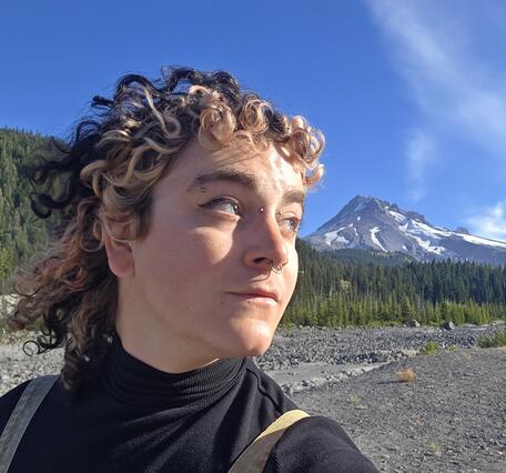 Woman with hat and flowing hair and life vest in profile picture