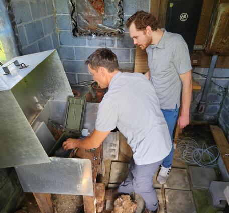 A scientist shows a reporter the various monitoring equipment used to record and transmit water level data.