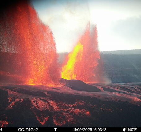 Color photograph of lava fountaining from two volcanic vents