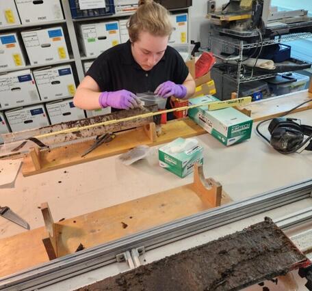 Person in a lab working with a sediment core