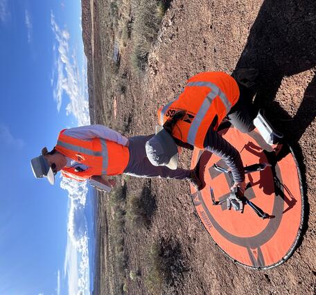 Two drone pilots set up equipment to be used in study near Moab, Utah