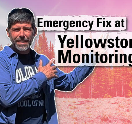 Thumbnail image of a man gesturing towards trees in the background