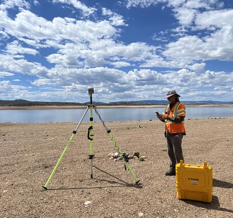 USGS remote pilot setting up instruments near the shore of Williams Fork Reservoir