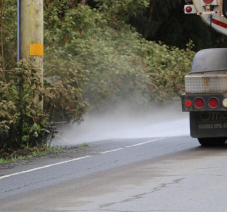 Color photograph of truck cleaning ash 