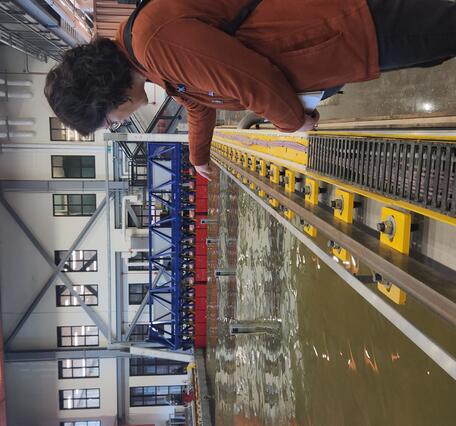 person gesturing into the experimental test basin at the HIF