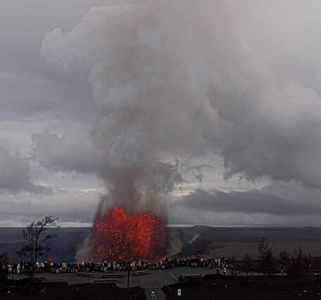 Color webcam image showing visitors at a National Park overlook viewing a lava fountain 