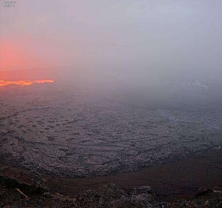 Color photograph of lava fountain and lava flow within crater