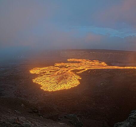 Color webcam image showing lava fountain and lava flow within crater as sunsets