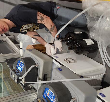 scientist collecting water samples in a hydraulics lab