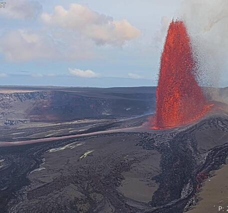 Color photograph of lava fountain erupting within crater