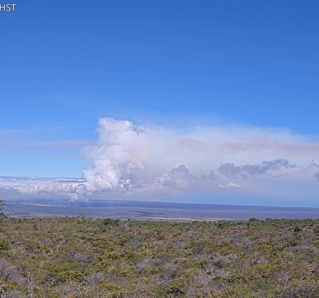 Color photograph showing volcanic plume in the distance