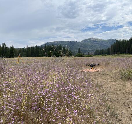 UAS craft, instruments, and landing pad in mountain clearing