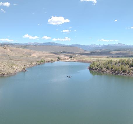 Overhead view of Willow Creek Reservoir, Colorado with drone craft flying above it.