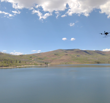 Drone aircraft flies above the surface of Willow Creek Reservoir
