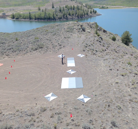 Overhead view of reservoir shore showing calibration/validation equipment used by drone sensors.