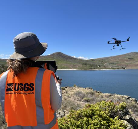 USGS drone pilot flies craft over reservoir