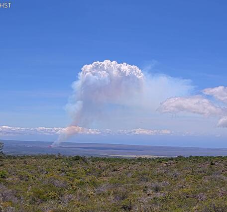 Color webcam image of a volcanic plume rising above an eruption site
