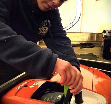 A girl using a screw driver.