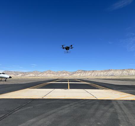 Drone hovering above airstrip at Grand Junction Regional Airport.