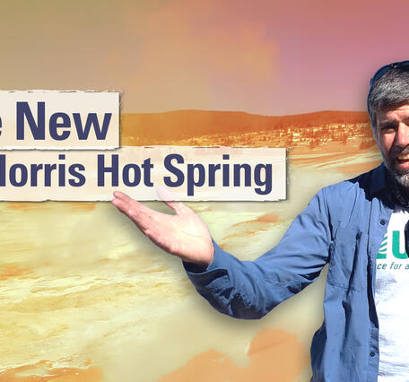 Man gesturing in front of a barren landscape with title "The New Norris Hot Spring"