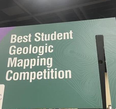 Large green rectangular sign reading "Best Student Geologic Map Competition"
