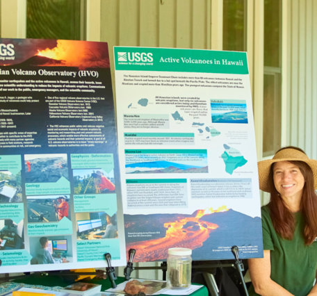 Color photograph of scientist at information table