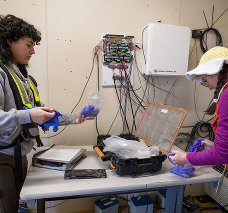Zoë Siman-Tov (left) and Amelia Ayers gather shellfish samples collected at Martinez Harbor in Contra Costa County, CA.