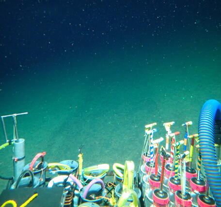 View from the Alvin showing mud and the devices to collect samples from the seafloor including cores