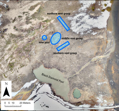 Aerial view with a muddy pool at the bottom and barren ground in the middle with blue polygons showing new vent locations