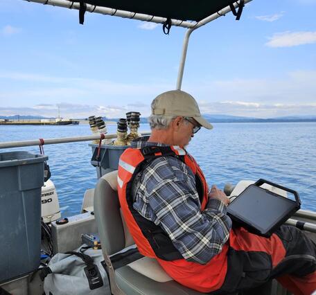 Man entering data on a boat