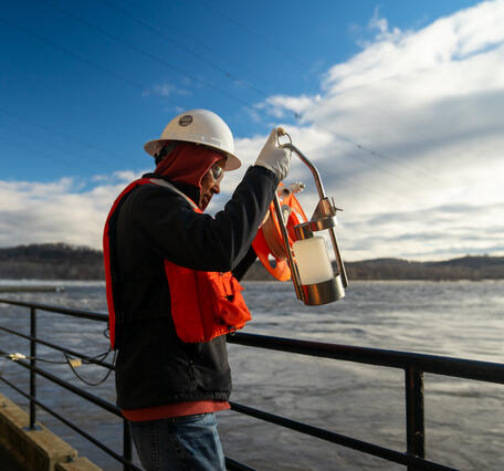Hydrologic technician Fisseha Mengistu reels in a sampling bottle.